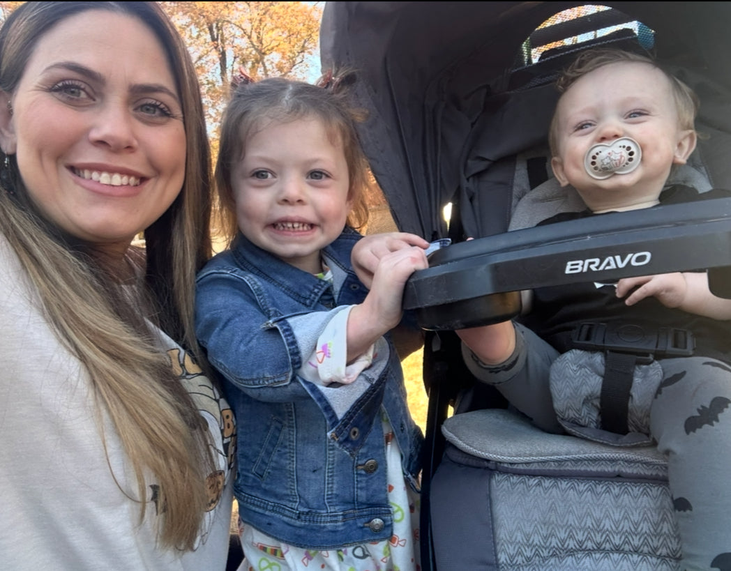 Rose smiling outdoors in autumn with her daughter and her baby son in a stroller