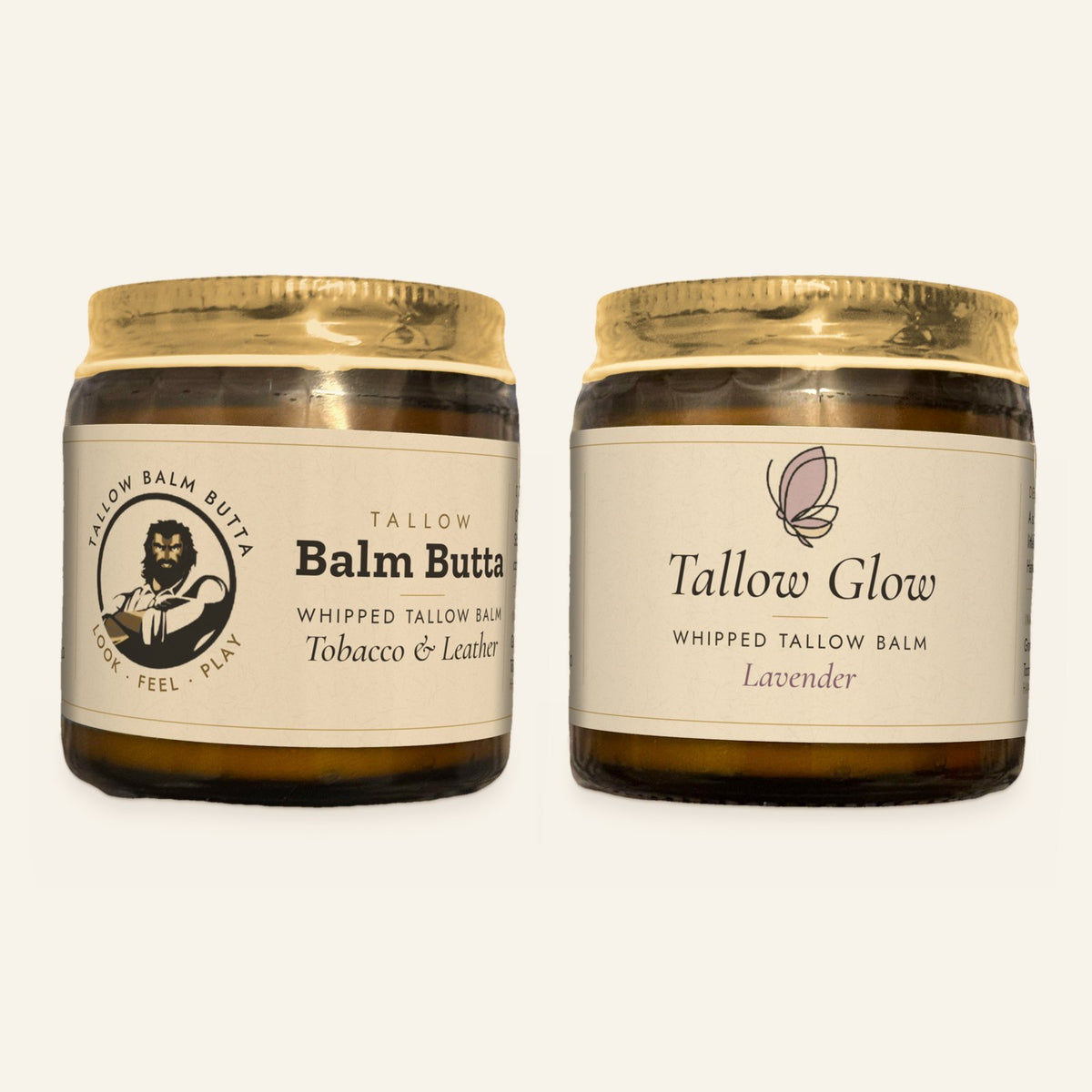 Two jars of Tallow Roots whipped tallow balm side by side, each with a gold lid and cream label: Balm Butta in Tobacco & Leather and Tallow Glow in Lavender