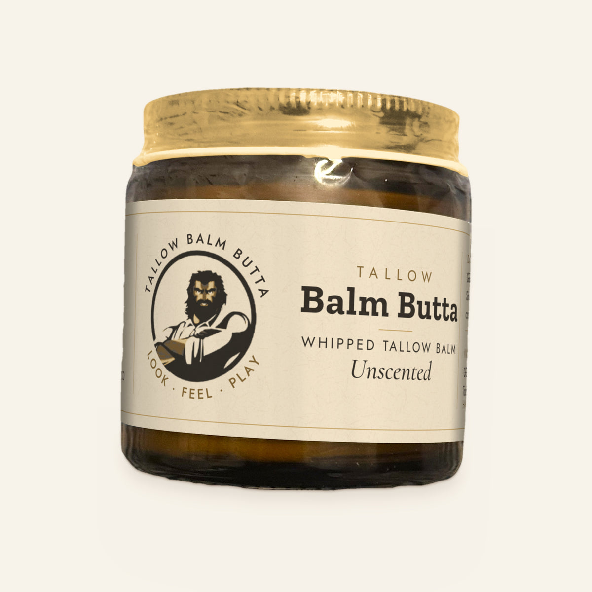 Tallow Roots Co. Unscented Balm Butta whipped tallow balm in a glass jar with gold lid and cream label, front view on a plain cream background