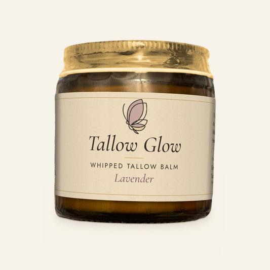Tallow Roots Co. Lavender Tallow Glow whipped tallow balm in a glass jar with gold lid and cream label, front view on a plain cream background