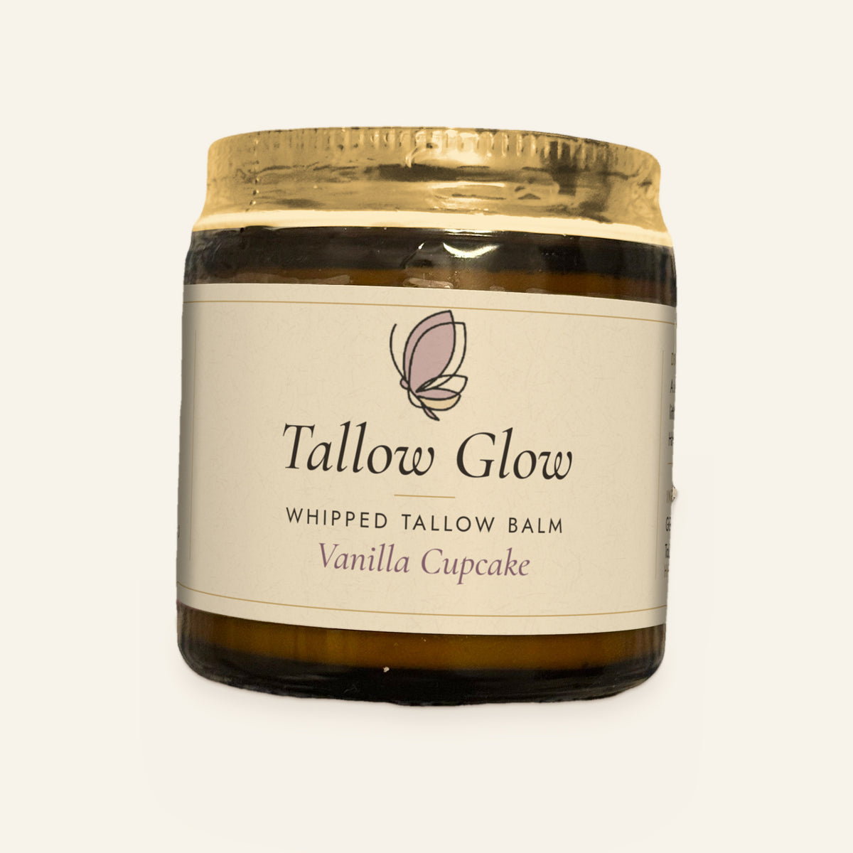 Tallow Roots Co. Vanilla Cupcake Tallow Glow whipped tallow balm in a glass jar with gold lid and cream label, front view on a plain cream background